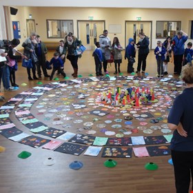 children celebrating their art work with parents