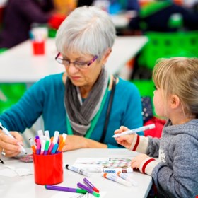 Families having fun drawing together