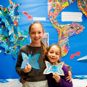 Children with their beautiful blue morpho butterflies